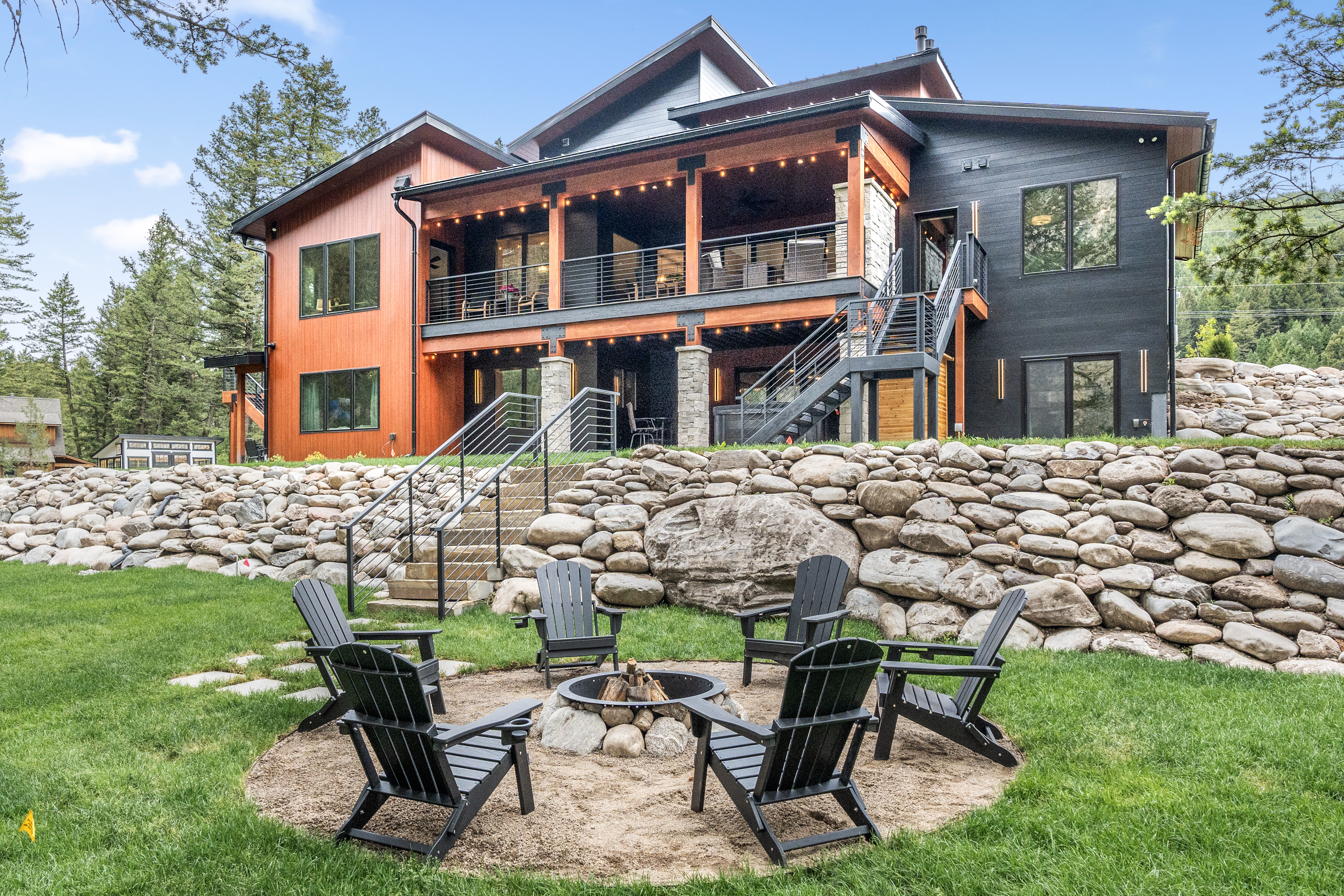 Rear exterior with fire pit and Adirondack chairs